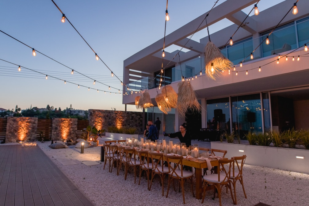 Preparing the table setup and ambiance at one of Ezoria's villas iin Cyprus for a private banquet function