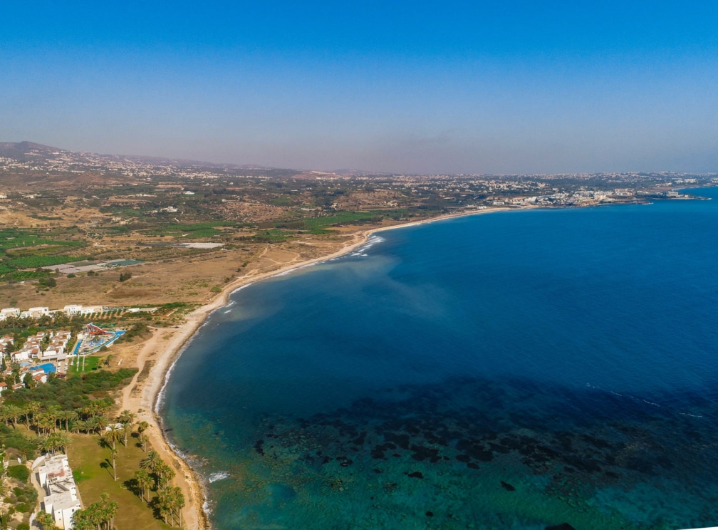 A high angled photo of the sea, surrounded by a vast stretch of land