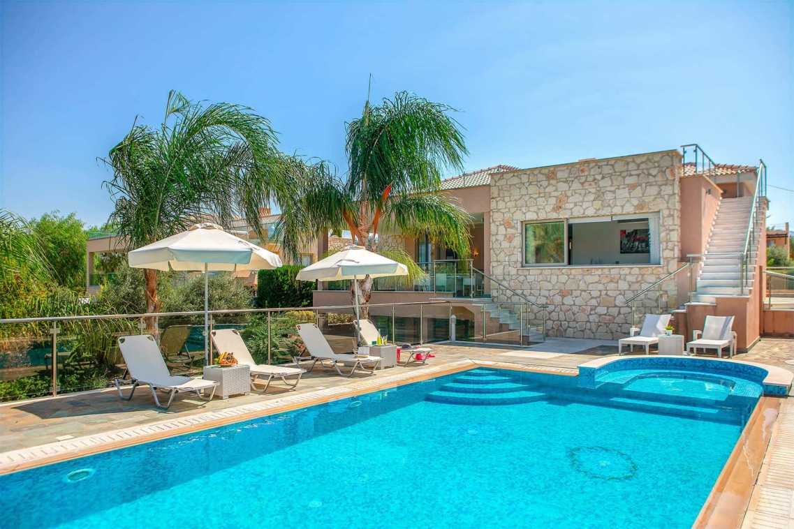 Exterior Large villas in Cyprus with pools showing the pool and deck with sun loungers and palm trees