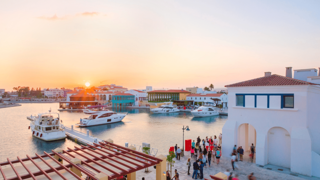 A harbour surrounded by some building. Some boats are on the water.